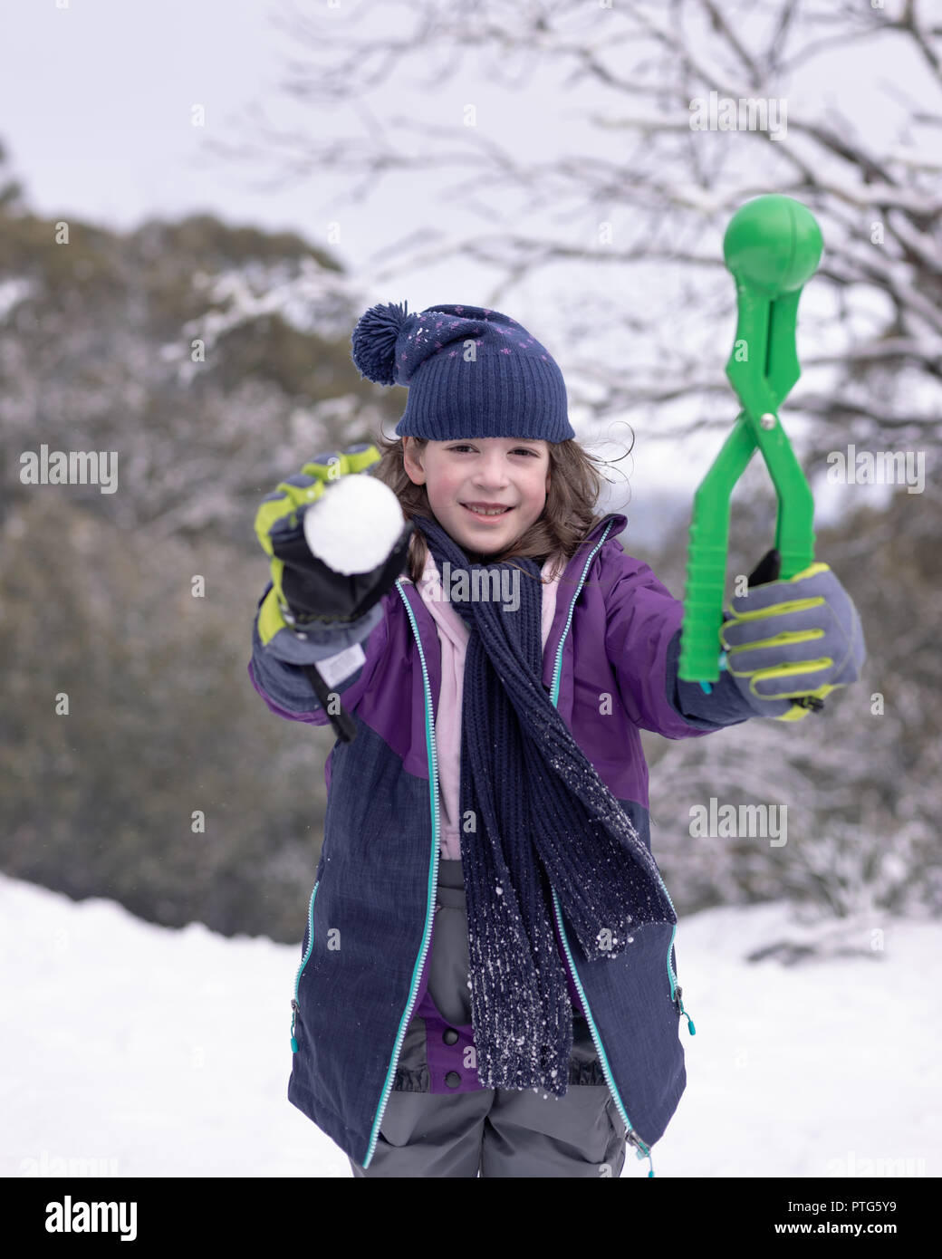 Junge Mädchen zeigt einen Schneeball, die Sie mit Ihrem Schneeball Teekocher gemacht Stockfoto