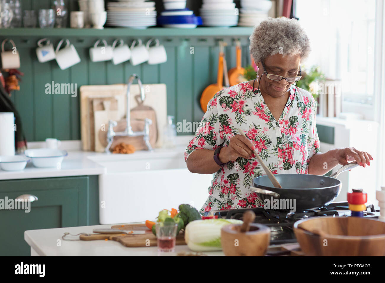 Active Senior Frau Kochen in der Küche Stockfoto
