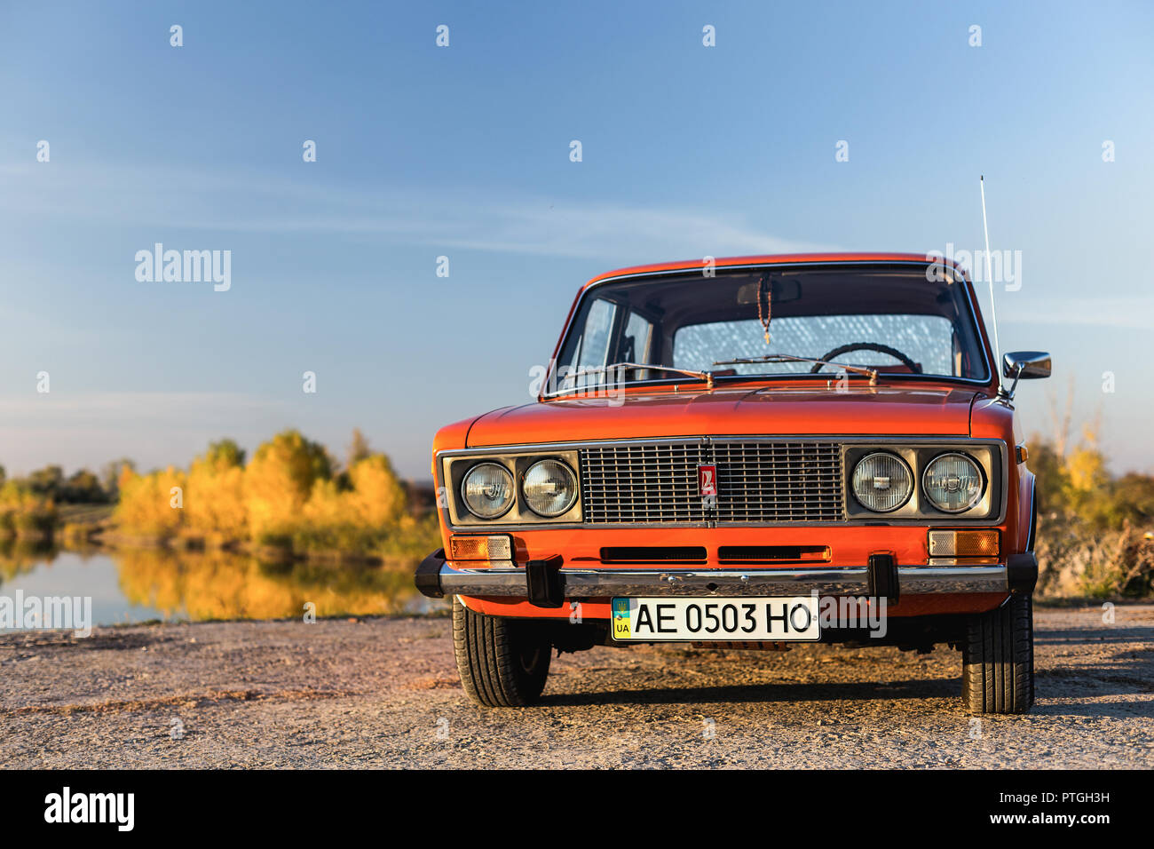 PERESHCHEPINO, UKRAINE - Oktober 12, 2014: Zhiguli VAZ 2106 original Orange, in der UDSSR in den 70er Jahren veröffentlicht. Auto in der Nähe des Flusses geparkt, autuman Zeit Stockfoto