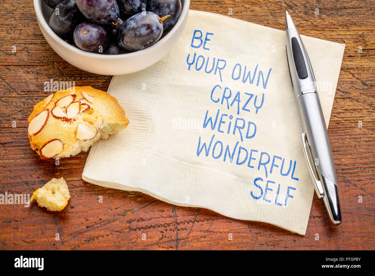 Eine eigene Verrückte, schräg, wunderbar selbst inspirationla Handschrift auf Serviette mit Trauben und Cookie. Stockfoto