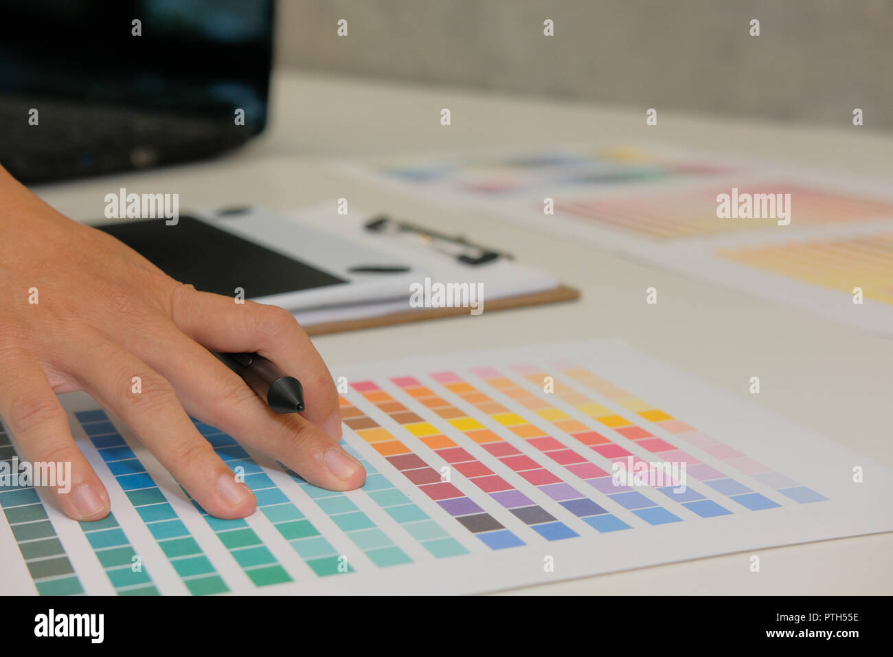 Grafik Designer wählende Farbe von Swatch Sample Katalog palette Guide am Arbeitsplatz. artist design & Idee für Kreativität Projekt. Stockfoto