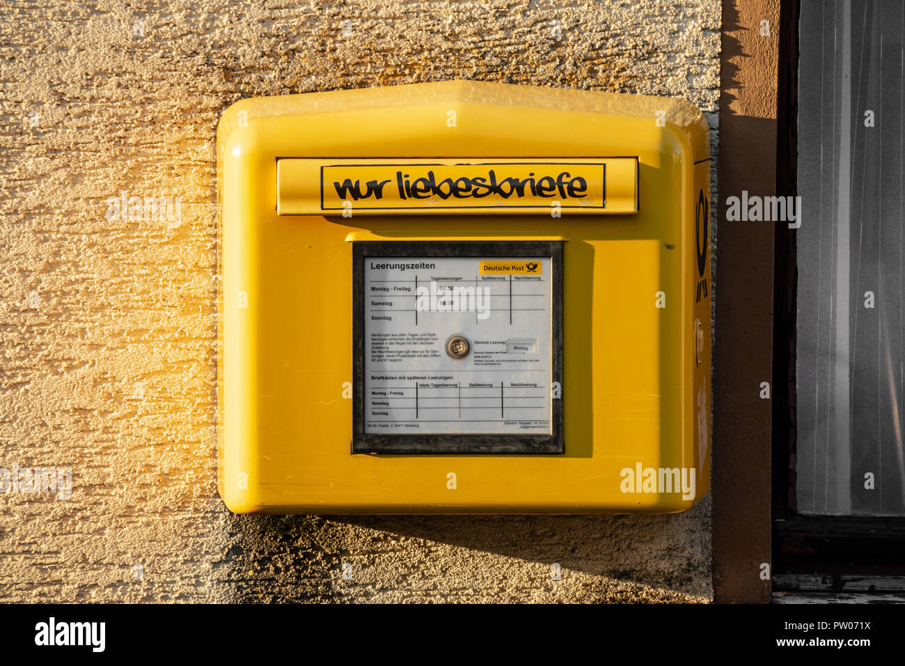 Standard gelben Briefkasten der Deutschen Post, mit (ironisch) Schriftzug "nur Liebesbriefe' Stockfoto