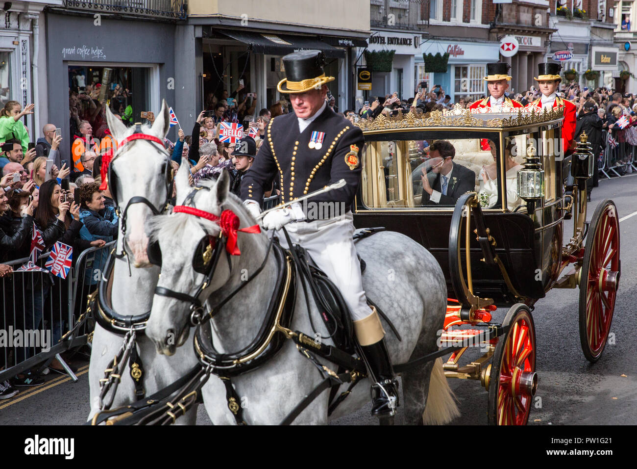 Windsor, Großbritannien. 12. Oktober, 2018. Ihre königliche Hoheit Prinzessin Eugenie, Frau Jack Brooksbank, und ihr Ehemann Jack Brooksbank eine Beförderung Prozession entlang Windsor High Street nach ihrer Hochzeit in St. George's Chapel in Windsor Castle genießen. Die geschlossenen schottischen Zustand Trainer war aufgrund der hohen Winde verwendet. Credit: Mark Kerrison/Alamy leben Nachrichten Stockfoto