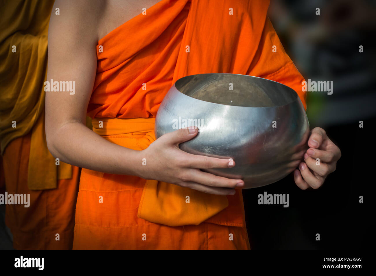 Mönchen Almosen - runde oder empfangen Essen angeboten. Fokus auf Almosen Schüssel. Stockfoto