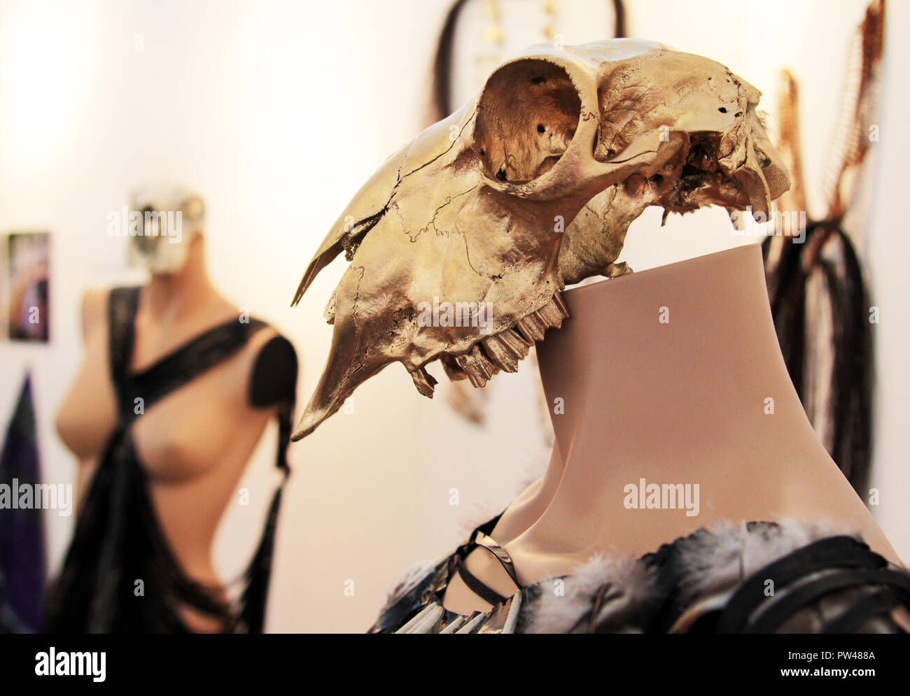 Eine dubiose Verbindung von Kunst und Mode mit einem Vögel Kopf Skelett und eine Mode mannequin als Näherin in einem Arts Show verwendet. Stockfoto