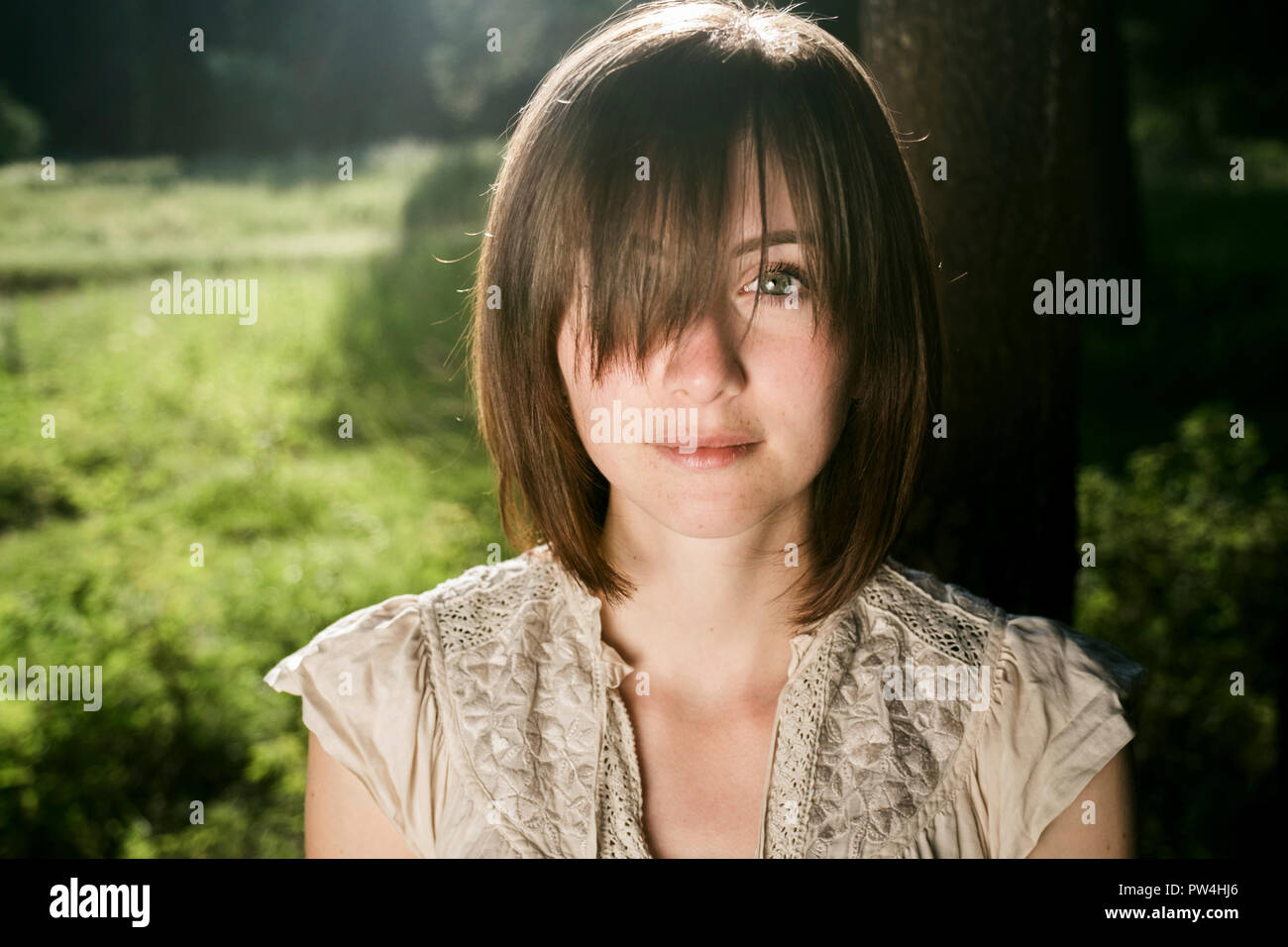 Porträt der jungen Frau mit Bangs im Wald Stockfoto