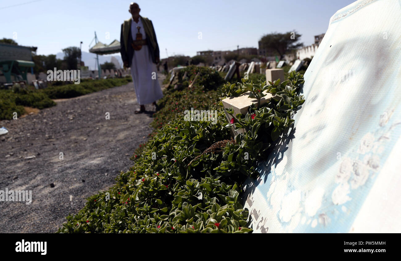 Sanaa, Jemen. 12 Okt, 2018. Ein Mann geht durch die Gräber der Kinder in Luftangriffen getötet wurden, auf einem Friedhof in Sanaa, Jemen, am Okt. 12, 2018. Die Menschenrechtskommission der Vereinten Nationen am Donnerstag forderte Saudi-Arabien seine tödlichen Luftangriffe gegen zivile Ziele im Jemen unter Reports, die sie in den Tod von mindestens 1.248 Kinder seit März 2015 in dem Land geführt haben. Credit: Mohammed Mohammed/Xinhua/Alamy leben Nachrichten Stockfoto