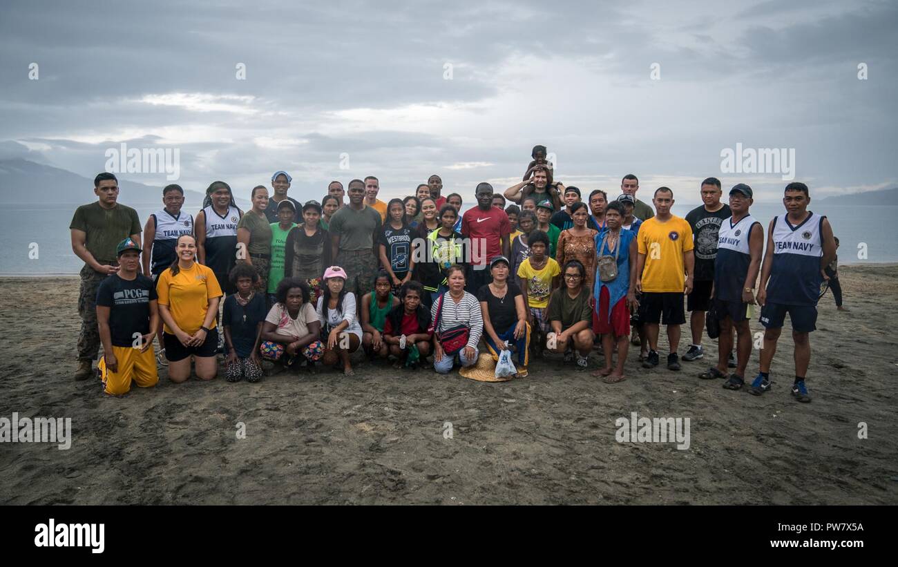 In den USA und der Philippinischen service Mitglieder und Freiwillige vor Ort zusammen, die nach Aufnahme Papierkorb für den Internationalen Coastal Clean-up Tag an cuaresma Strand zur Unterstützung der KAMANDAG in Casiguran, Aurora, Philippinen, Sept. 29, 2017. Die ICC-Tag ist eine jährliche Veranstaltung am gleichen Tag rund um den Globus statt. KAMANDAG ist ein Akronym für die Philippinischen Phrase "Kaagapay Ng Mga Mandirigma Ng Dagat", was übersetzt "Zusammenarbeit von Kriegern des Meeres", der Partnerschaft zwischen der Philippinischen und United States Militärs hervor. Stockfoto