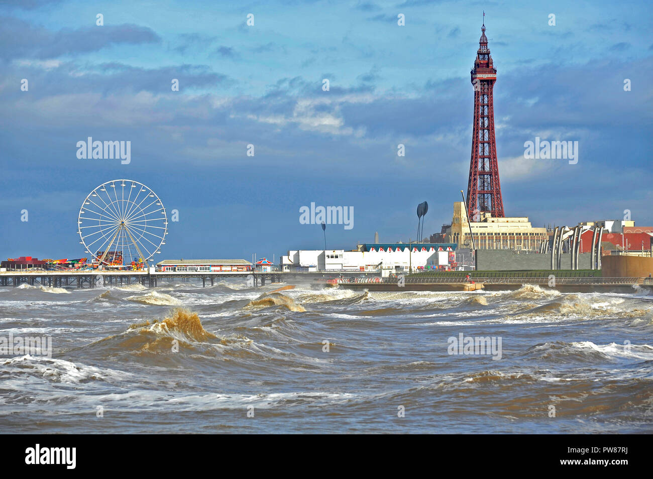 Große Wellen auf Blackpools Strandpromenade an einem warmen sonnigen Oktober Tag brechen Stockfoto