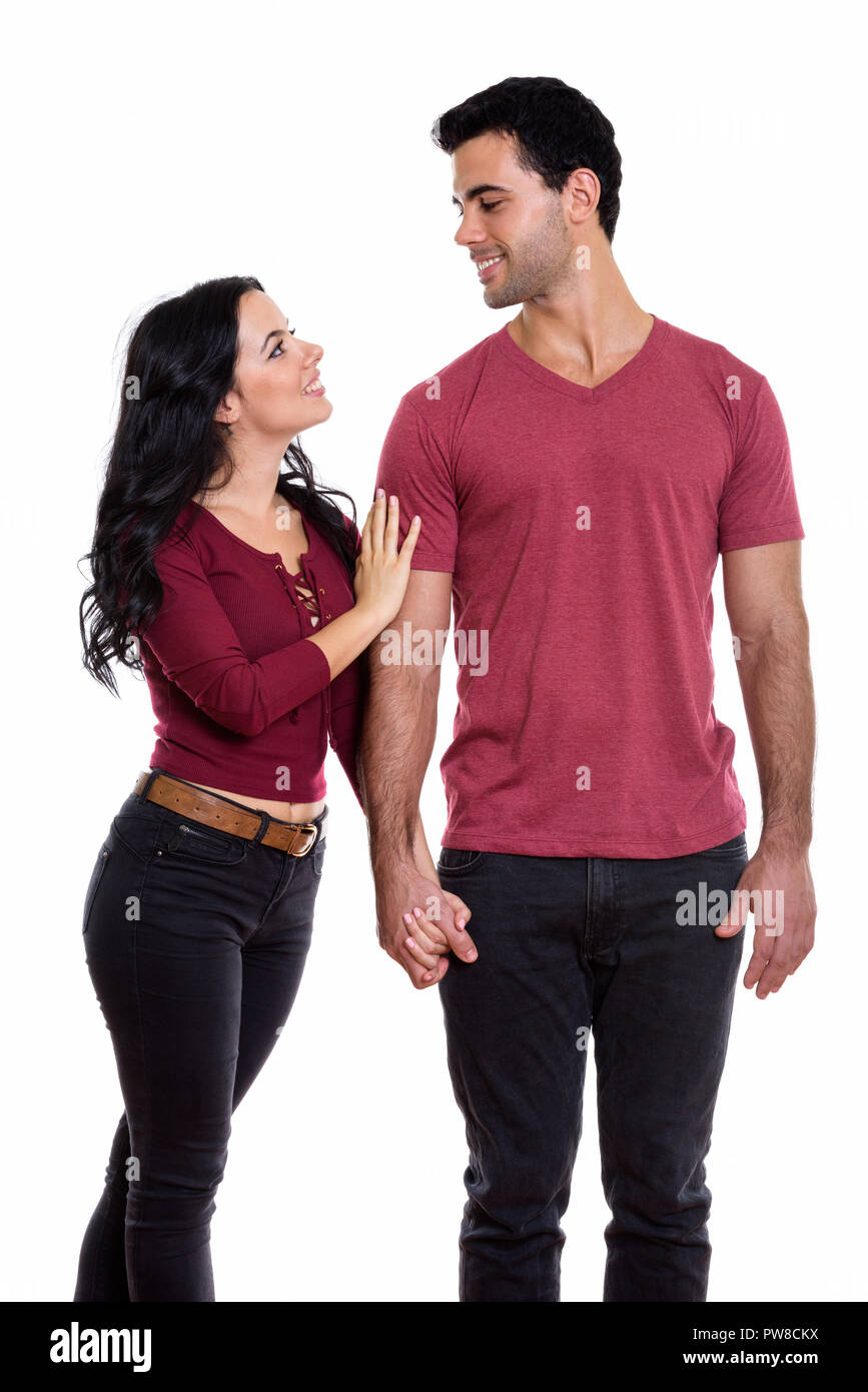 Profil anzeigen von jungen glückliches Paar lächelnd, während Hände halten ein Stockfoto