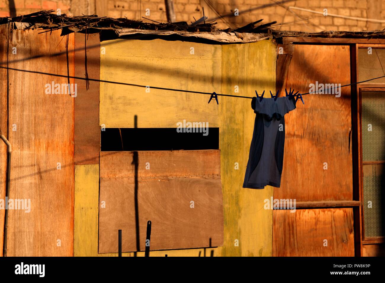 Einzelnes Element der Kleidung auf die Wäscheleine mit Wäscheklammern mit gelben und orangen Holz Hintergrund gesichert Stockfoto