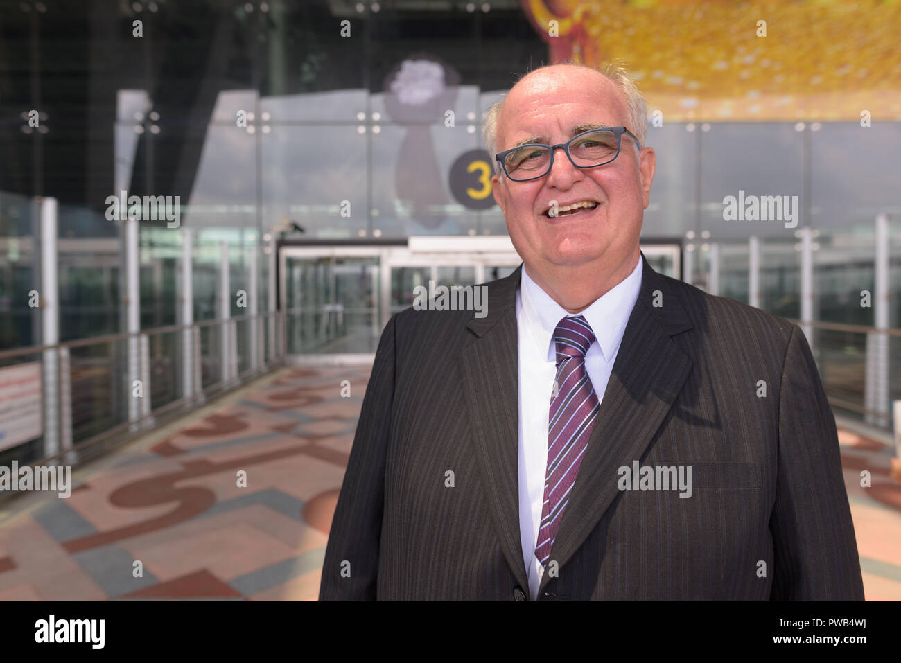 Übergewicht älterer Geschäftsmann Lounging rund um den Flughafen von Ban Stockfoto