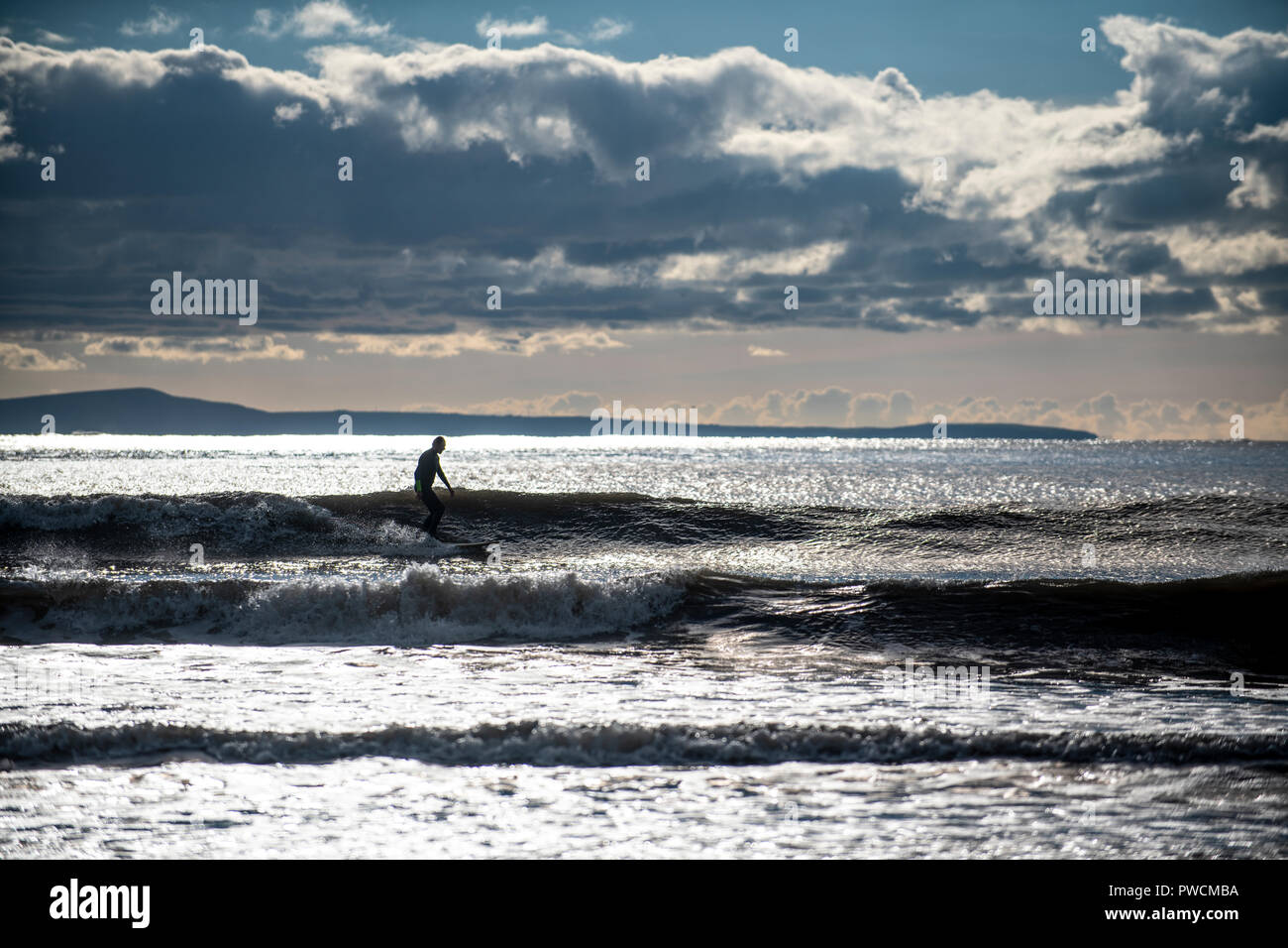 Eine männliche Surfer auf einer Welle an Dunraven Bay auf das Tal von Glamorgan Heritage Coast, South Wales. Sotherndown Strand. Stockfoto