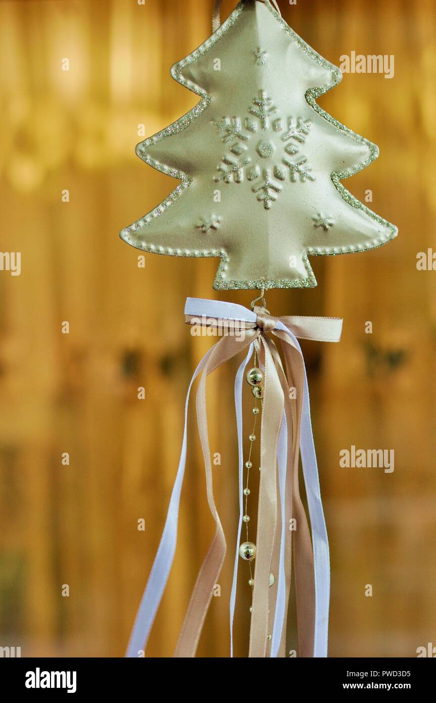 Weihnachten Dekoration mit einem Golden Tree mit farbiger Schnürung auf gelben Hintergrund. Vorderansicht, selektiven Fokus Stockfoto