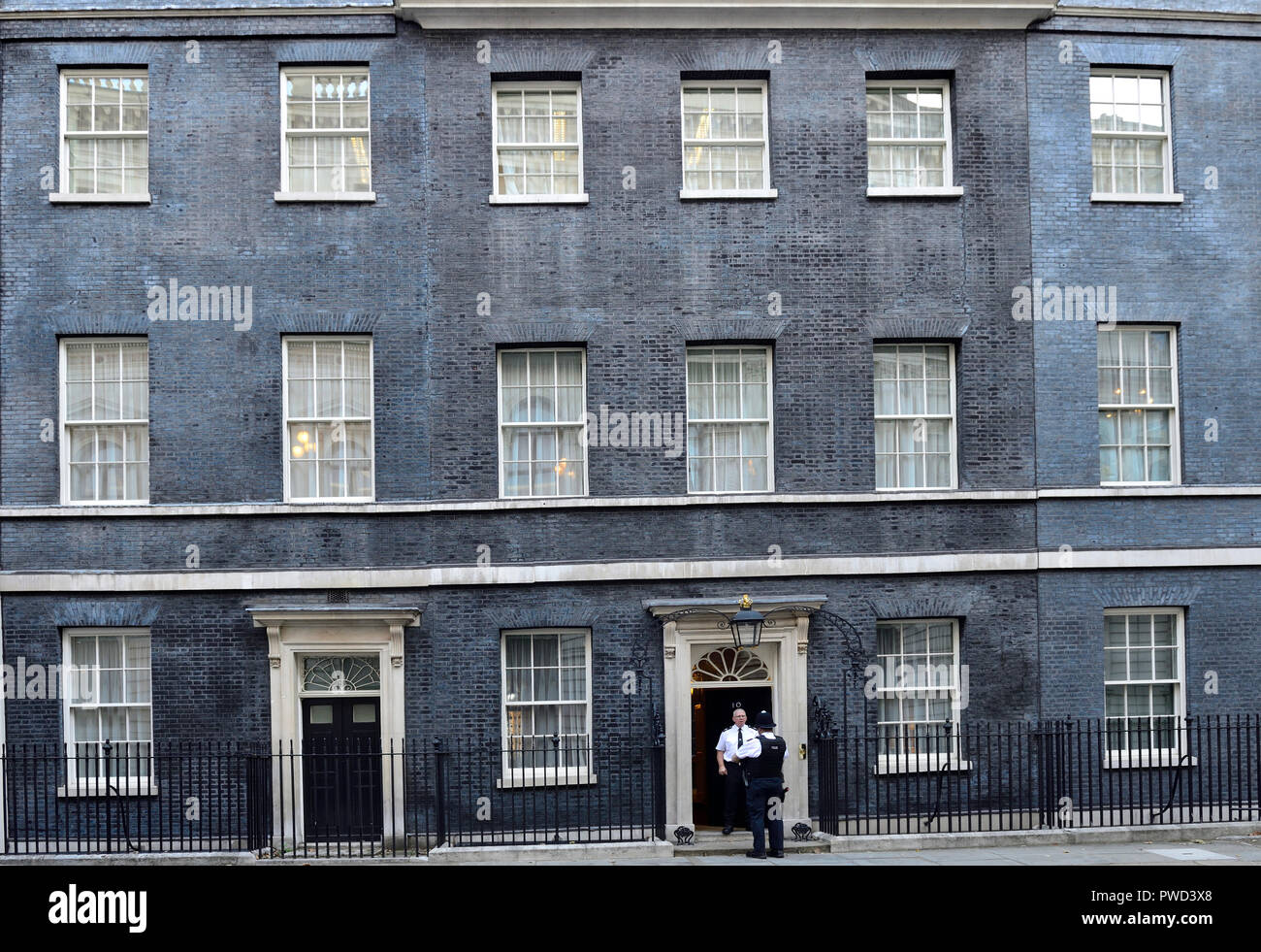 Polizisten sprechen in der Tür Nr. 10 Downing Street, London, England, UK. Stockfoto