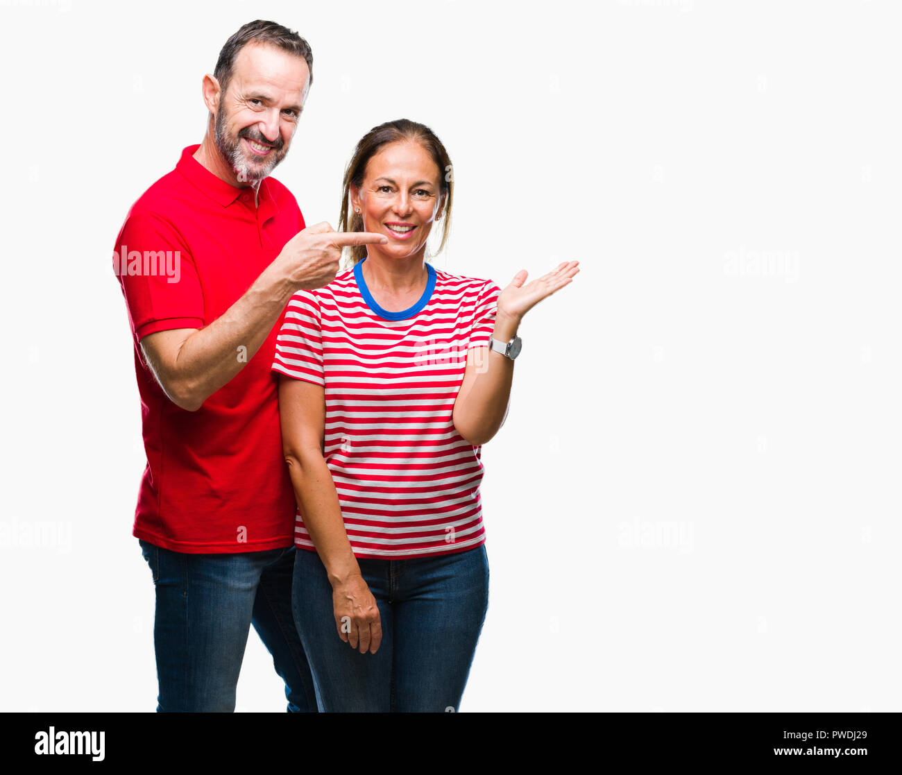 Mittleres Alter spanischer Paar in Liebe über isolierte Hintergrund erstaunt und lächelt in die Kamera während der Präsentation mit Hand und zeigte mit dem Finger. Stockfoto