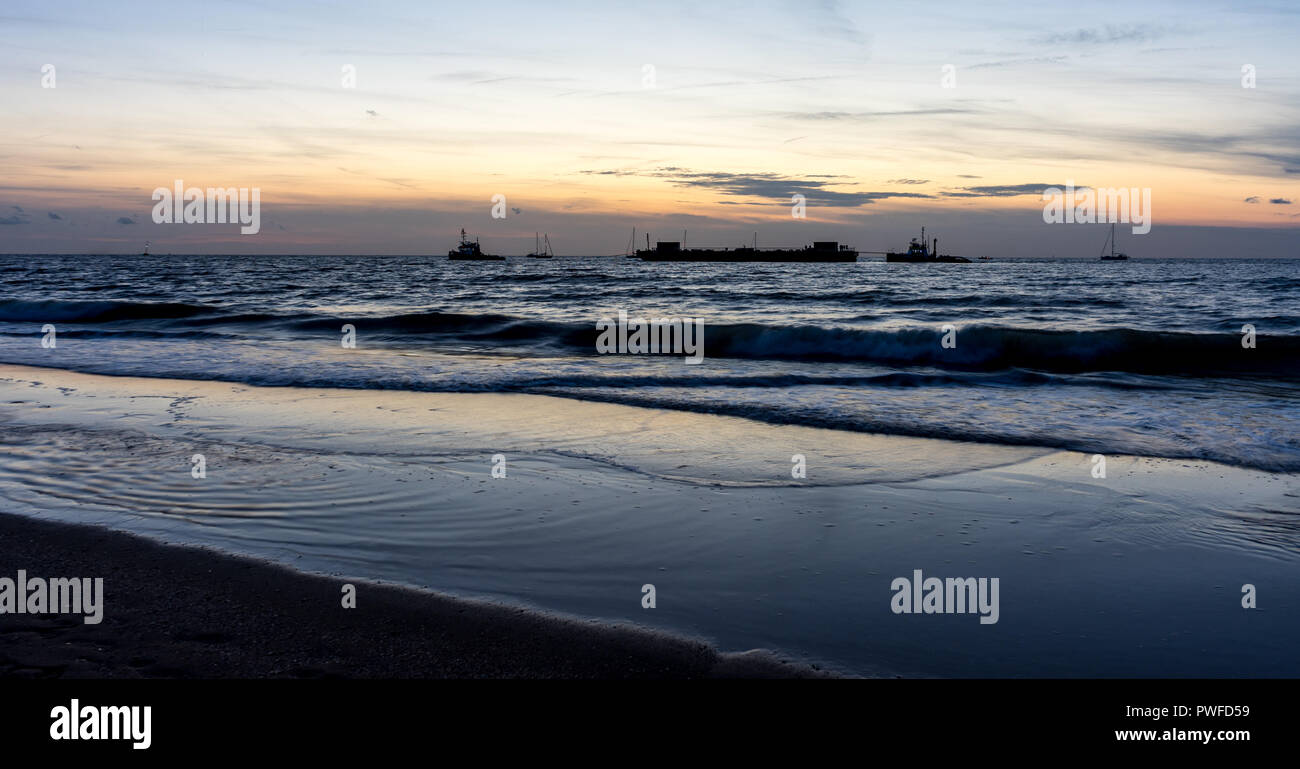 Niederlande, Den Haag, Scheveningen, Europa, ein Strand mit Sonnenuntergang im Hintergrund Stockfoto