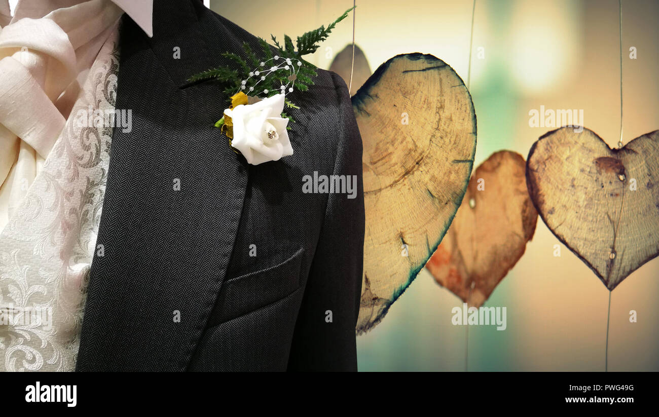 Mens Hochzeit Anzug schließen bis auf Holz Herz Hintergrund mit weißen Rose. Stockfoto