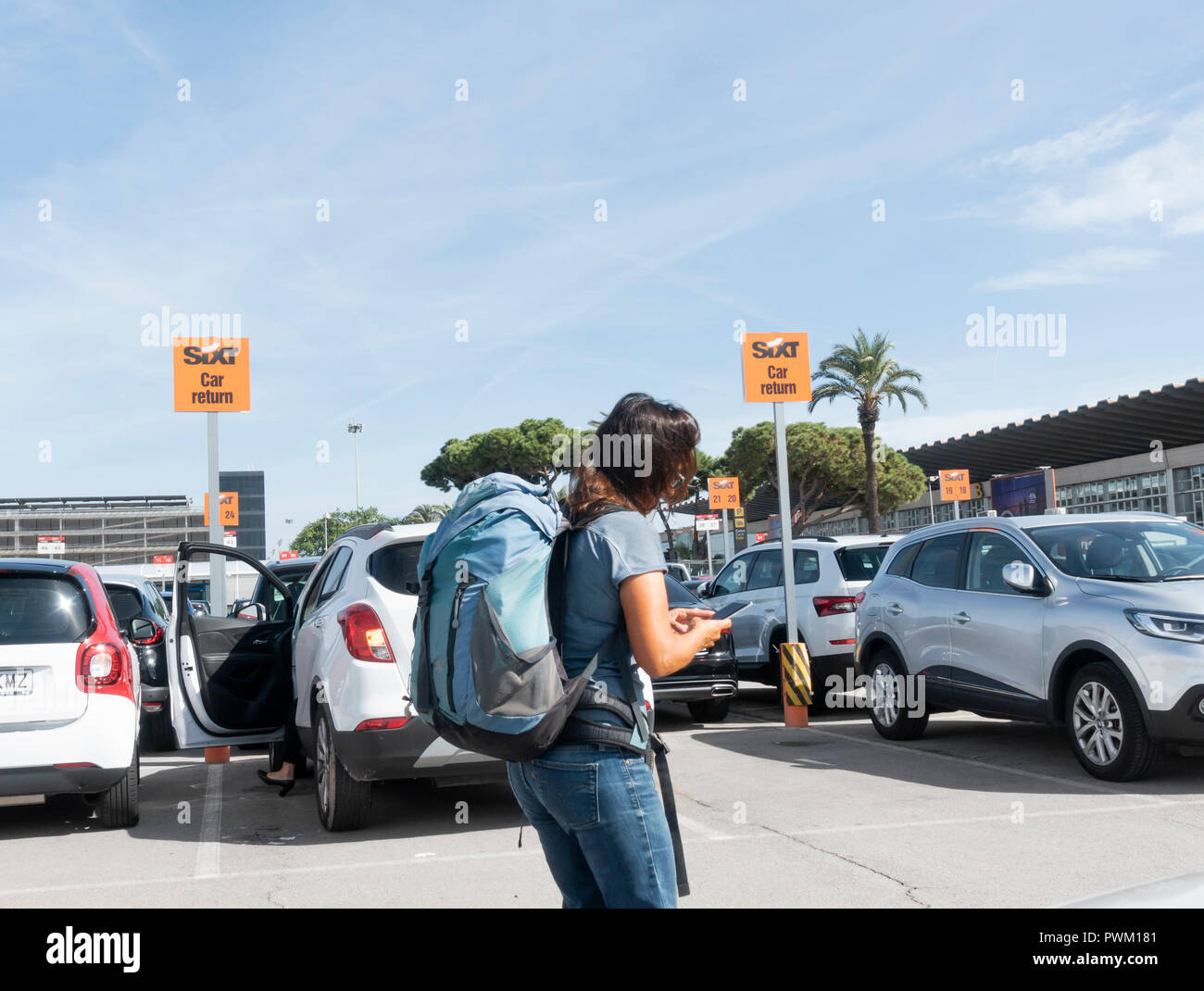 Weibliche Touristen herauf Mietwagen von Sixt Autovermietung compound am Flughafen Barcelona. Spanien Stockfoto