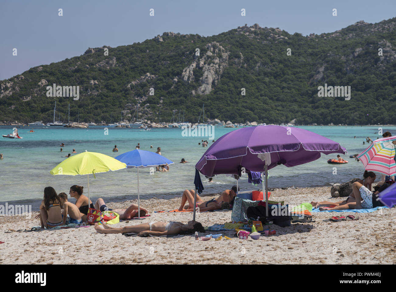 Menschen entspannen am Strand und im Wasser. Strand von Santa Giulia in Korsika. Plaża Santa Giulia na Korsyce. Ludzie wypoczywający na plaży. Stockfoto