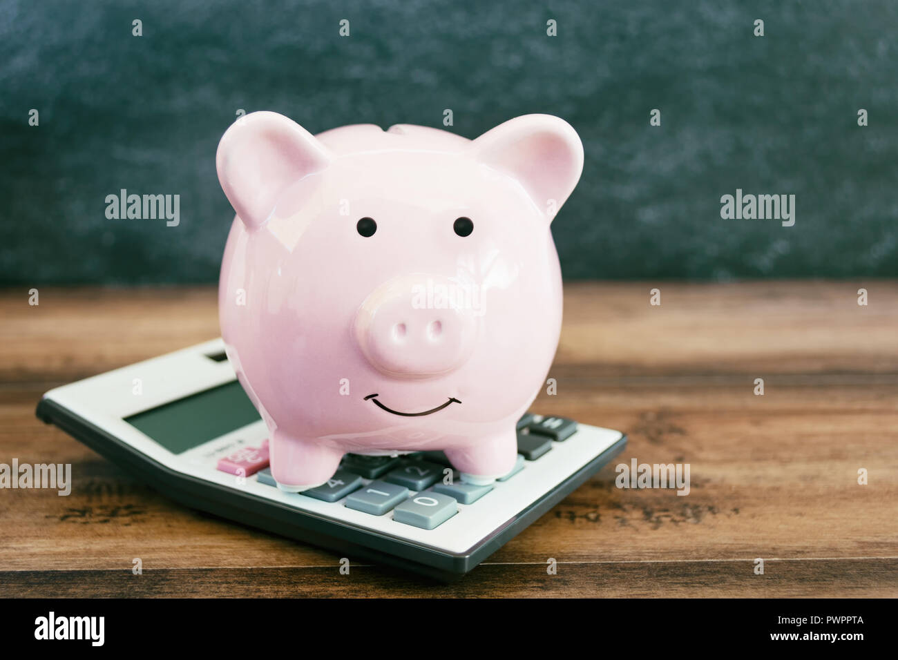 Geschäftliche und finanzielle Konzept - Sparschwein auf der Taschenrechner Stockfoto