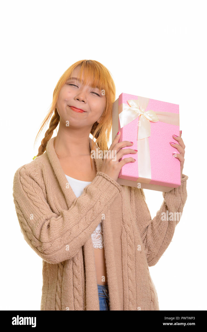 Junge nachdenklich asiatische Frau raten Geschenkbox Stockfoto