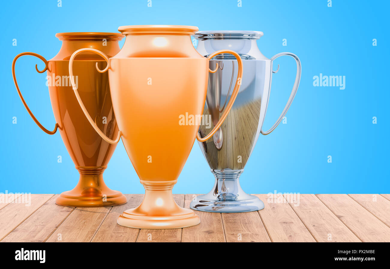 Gold, Silber und Bronze Trophy Cups auf dem hölzernen Tisch, 3D-Rendering Stockfoto