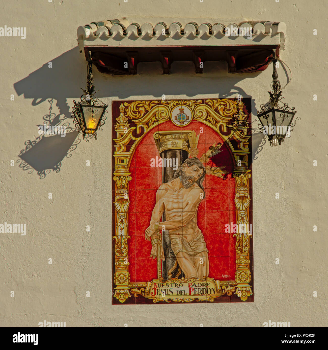 Malerei von Jesus mit Wunden, zu einer Säule gebunden, auf der Seite einer Kirche im Stadtviertel Albayzin in Granada, Spanien Stockfoto