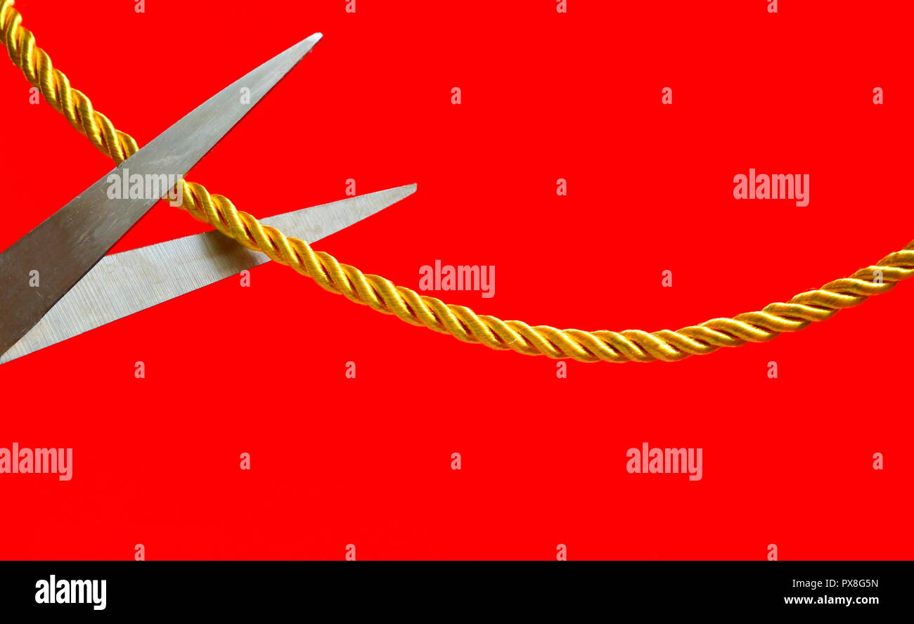 Eine Schere schneiden ein Seil, die Beziehungen zwischen beiden Seiten, Cut off Beziehung Konzept, Metapher Stockfoto