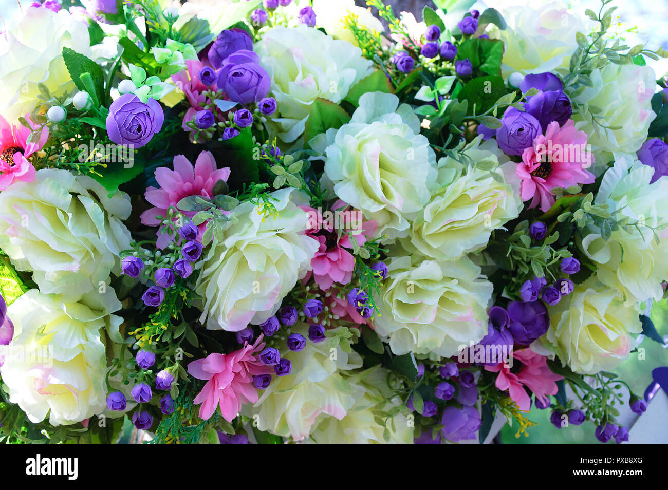 Zusammensetzung der Blumen von großen beige Rosen, kleine lila rosa Rosen und Astern. Stockfoto