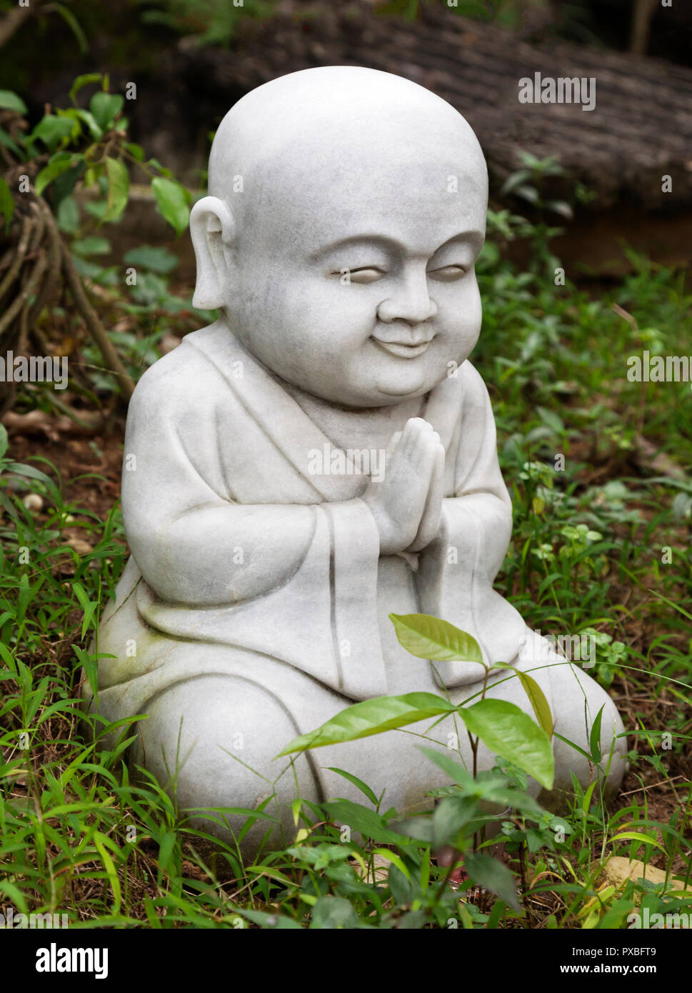 Kleine Buddha Statue in einem Garten Stockfoto
