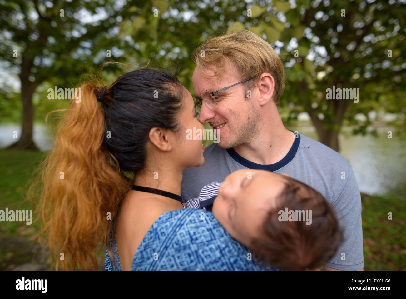 Multi-ethnischen junge Familie kleben zusammen im Park Stockfoto