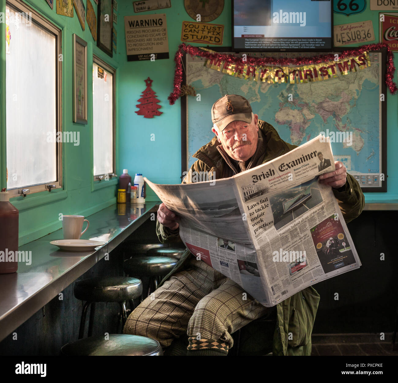 Co. Waterford, Irland. 08. Dezember, 2017. Tony Keane von Dungarvan liest die Zeitung beim Frühstück an der J.J.Diner bevor er erlischt für eine d Stockfoto