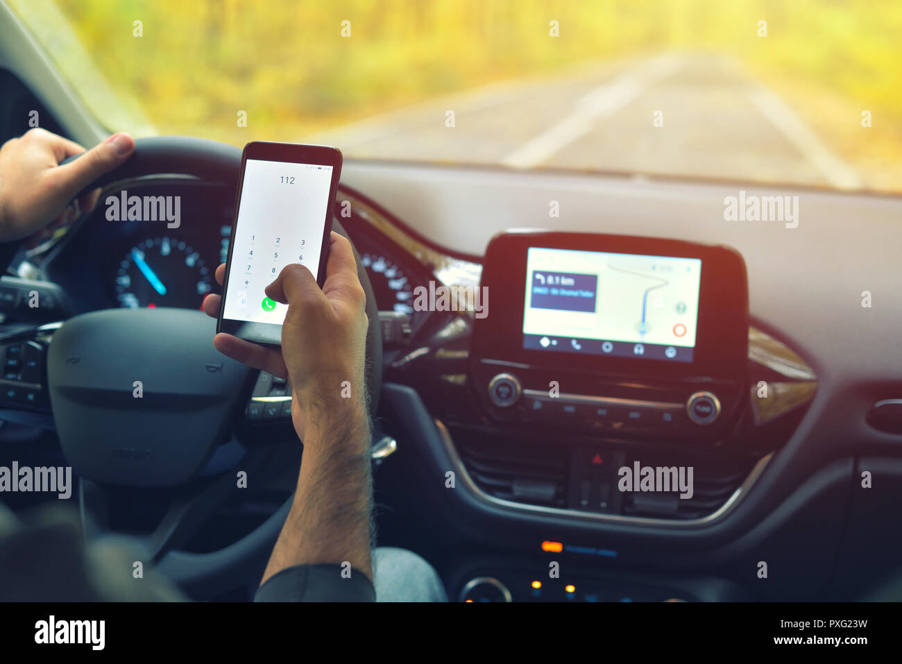 Männliche Fahrer mittels Smartphone zu 112 europäische Notrufnummer, während der Fahrt Stockfoto