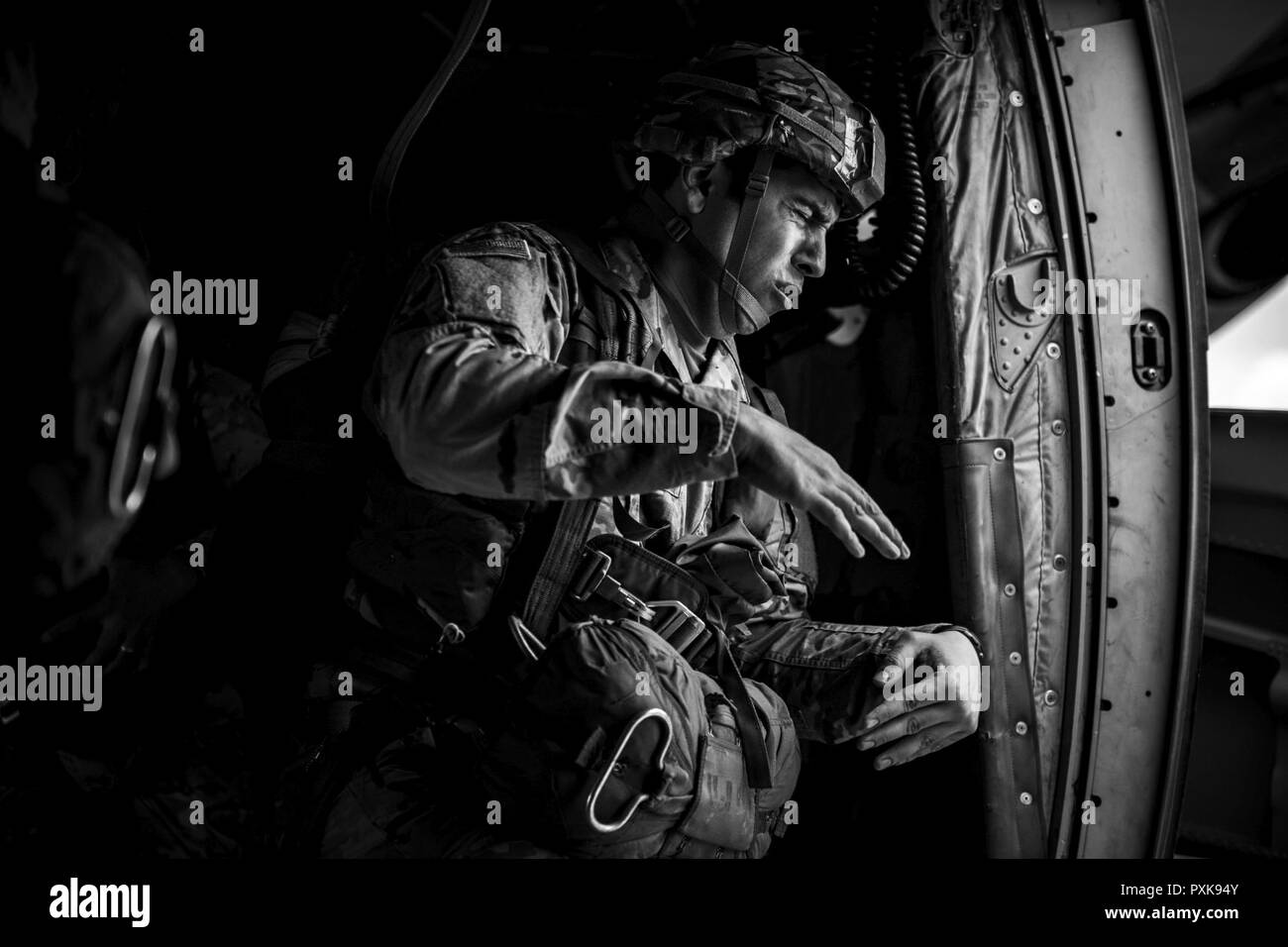 Ein Soldat der US-Armee klammern gegen den Wind aus der offenen Tür der US Air Force C-130J Super Hercules auf der 37th Airlift Squadron an der Air Base Ramstein, Deutschland zugewiesen werden, bevor sie in der Nähe von Sainte-Mere-Eglise, Frankreich, 4. Juni 2017 springen. Dieses Ereignis erinnert an den 73. Jahrestag des D-Day, den größten multinationalen amphibische Landung und operativen militärischen Airdrop in der Geschichte, und hebt die USA "unerschütterlichen Verpflichtung gegenüber den europäischen Verbündeten und Partnern. Insgesamt ca. 400 US-Mitgliedern aus Einheiten in Europa und den USA sind die Teilnehmenden in den zeremoniellen D-Day 73 Veranstaltungen f Stockfoto