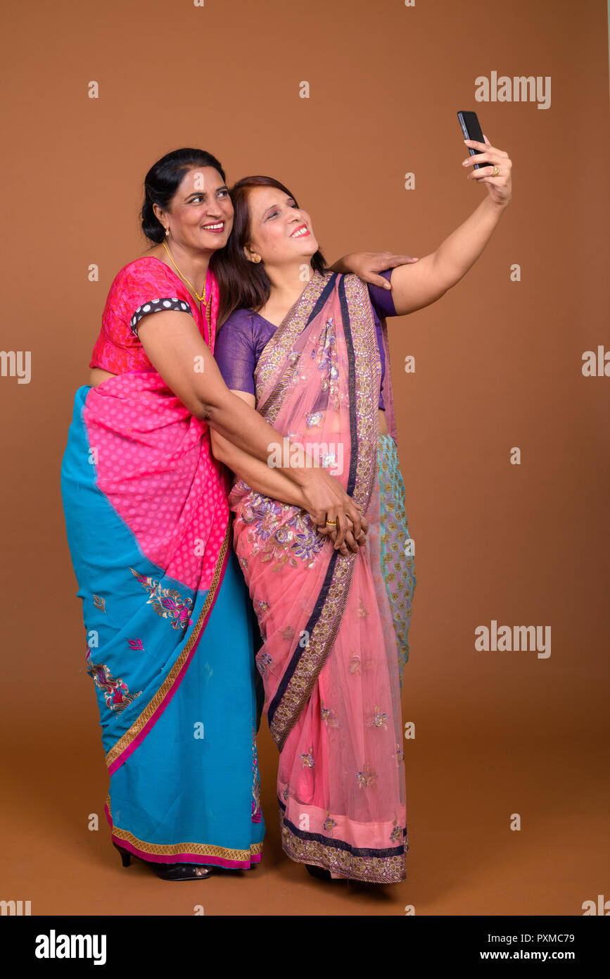 Zwei reife indische Frauen, die selfie mit Handy Stockfoto