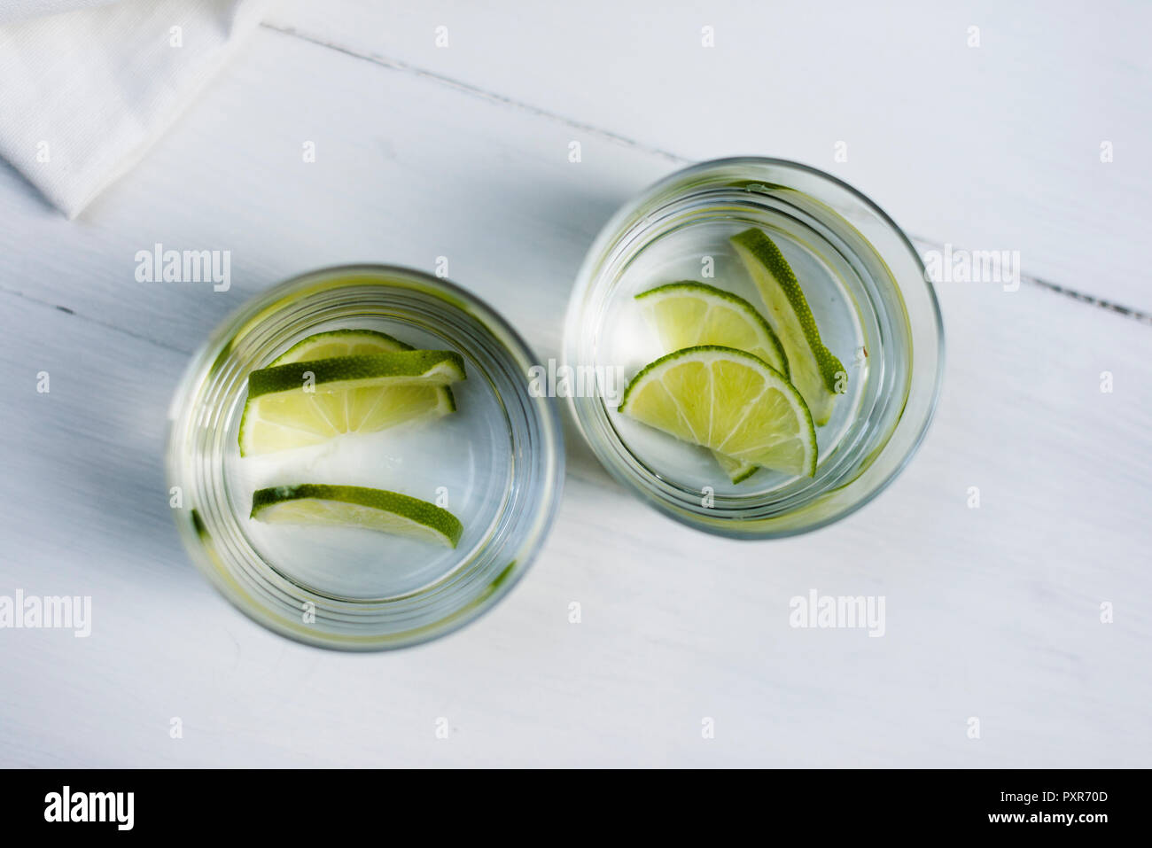 Zwei Gläser Wasser mit in Scheiben geschnittenen Limetten Stockfoto