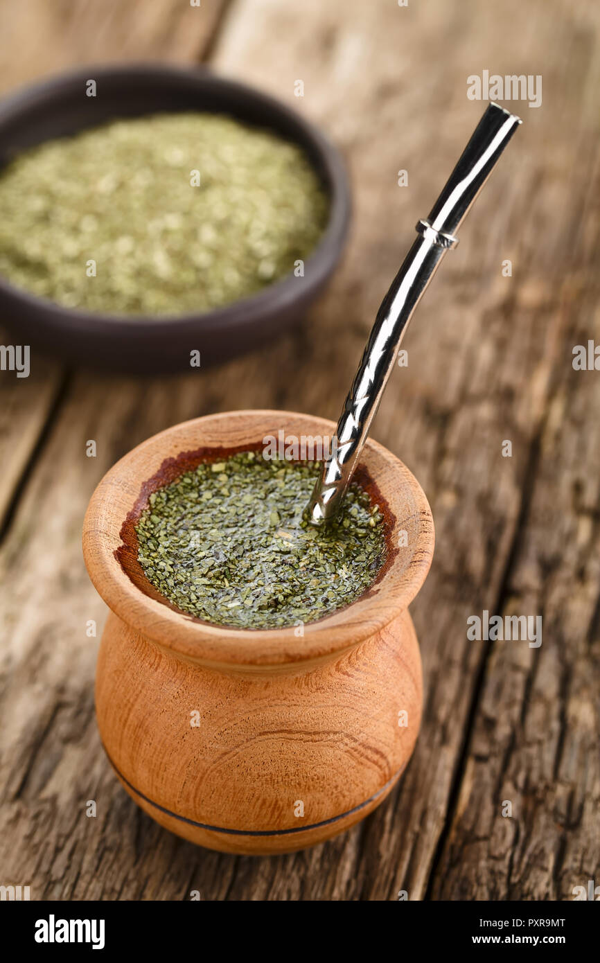 Die traditionellen Südamerikanischen Yerba Mate Tee in Holz- Mate Becher  mit Bombilla aus Metall Stroh als ein Sieb, auf rustikalem Holz  fotografiert dienen Stockfotografie - Alamy
