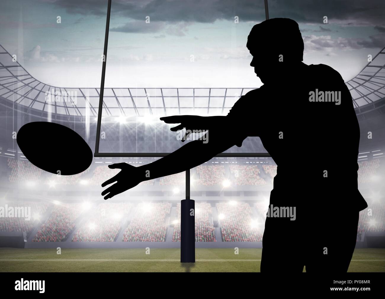 Digitale Komposition von Silhouette der Spieler fängt einen Rugby Ball im Stadion Stockfoto