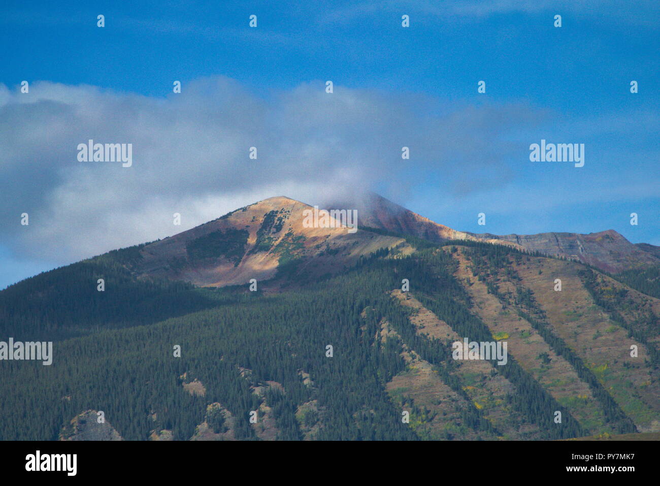 Colorado Mountain mit Pinsel und einer Wolke über hängende und wirft einen Schatten in einem blauen Himmel. Stockfoto