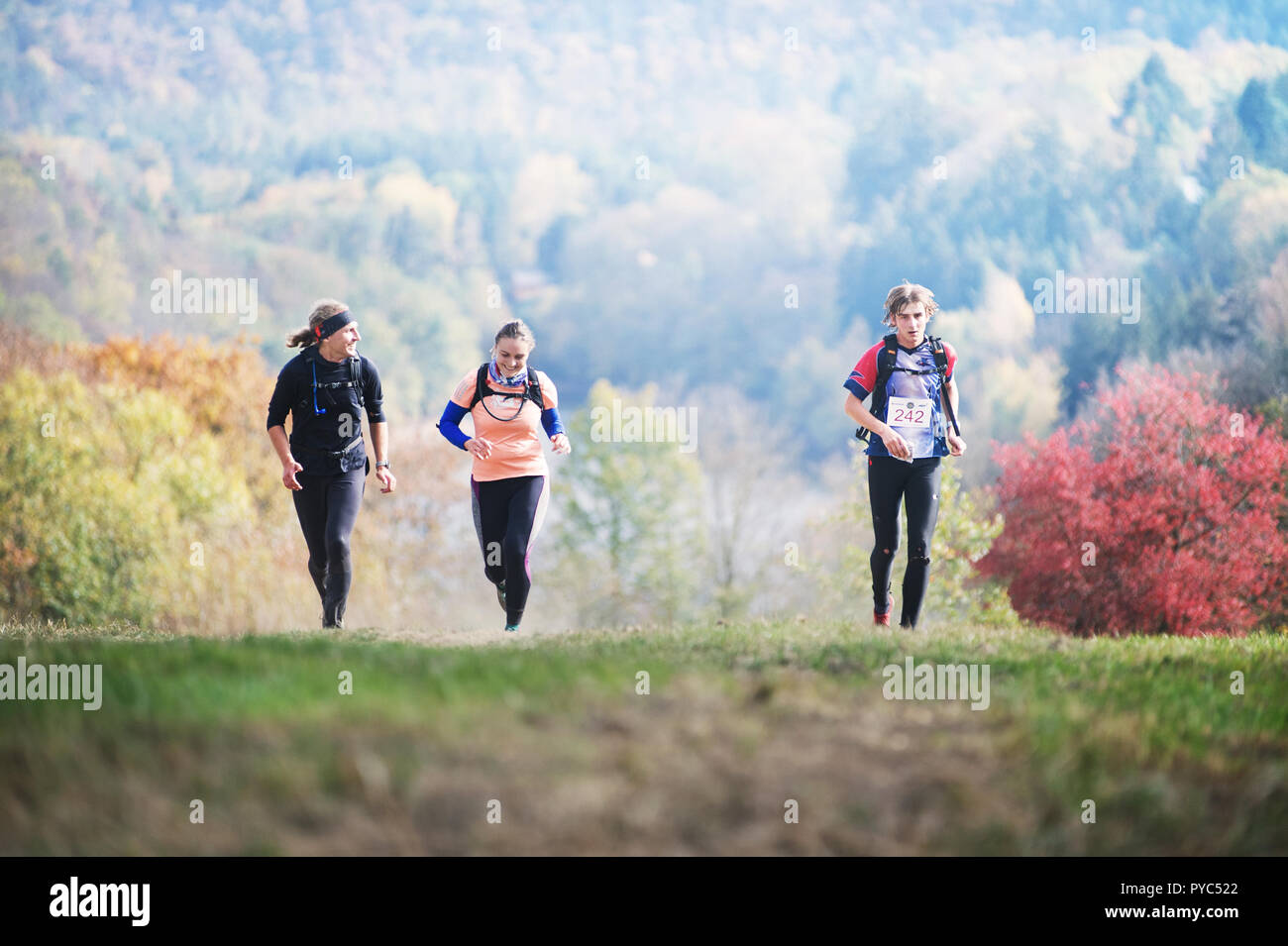 Tschechische Republik, SLAPY, Oktober 2018: Trail Maniacs laufen. Mann Competite mit jungen Paar. Die herbstlichen Wald für den Hintergrund. Stockfoto