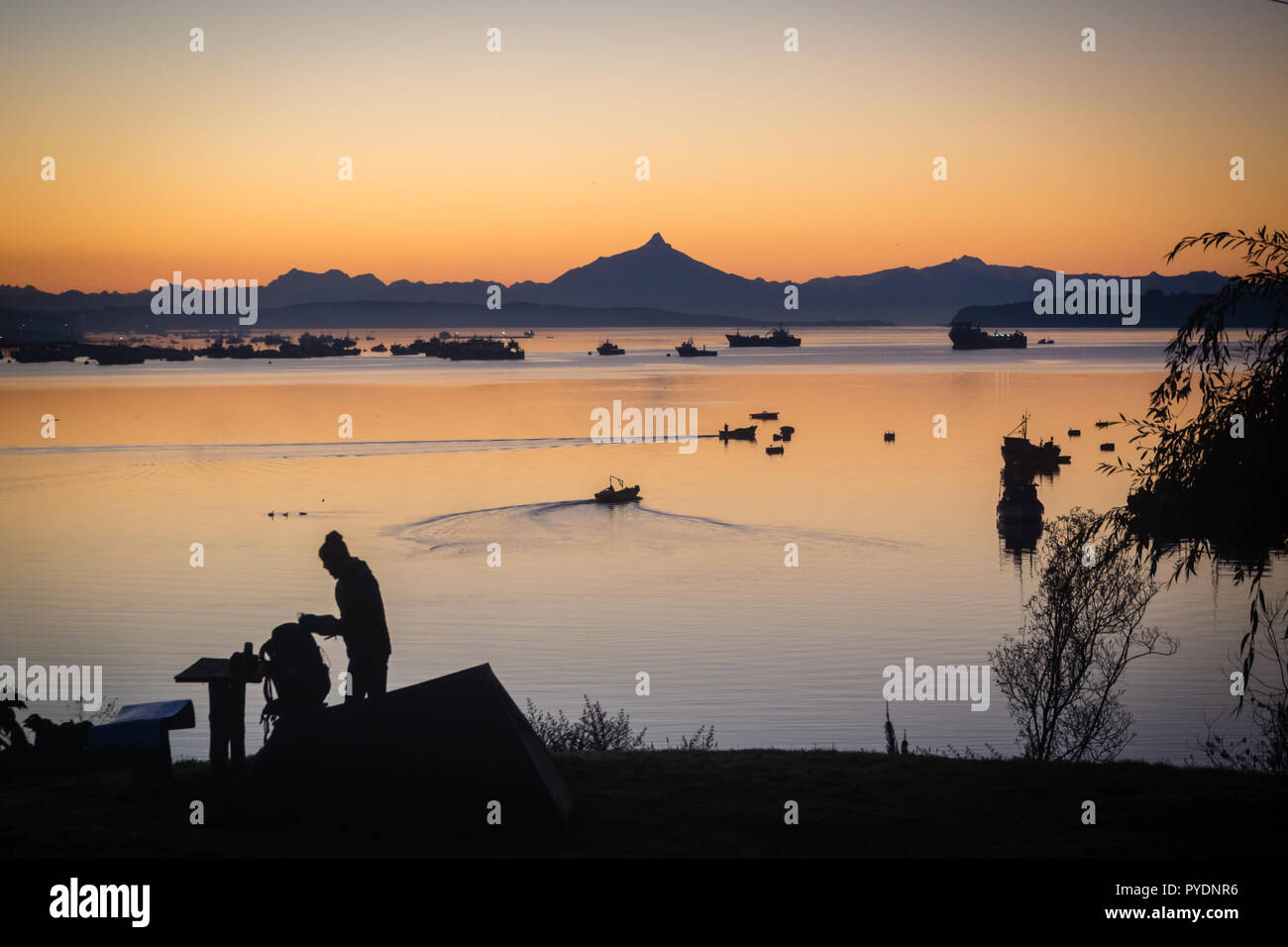 Sonnenaufgang in den Hafen von Quellon in Chiloe Insel. Patagonien in Chile. Silhouette Stockfoto