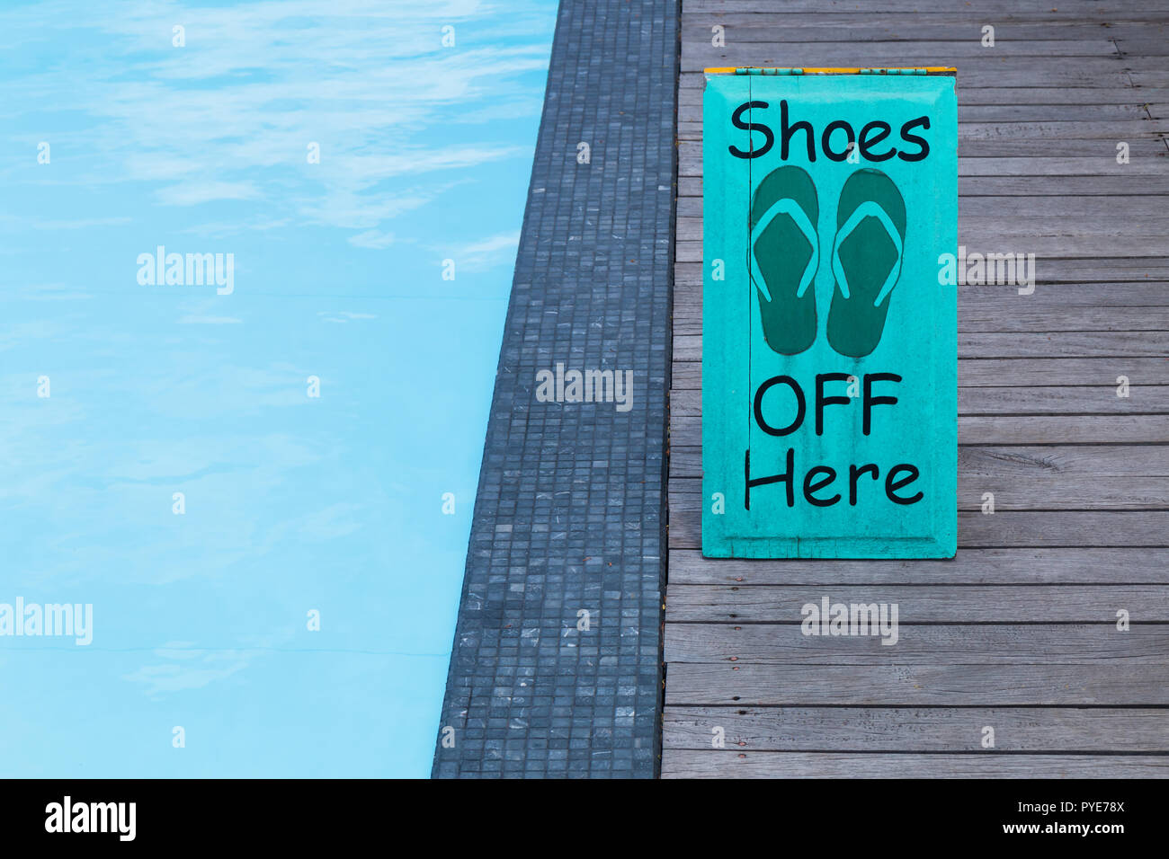 Keine Schuhe anmelden, indem das Schwimmbad auf dem Holzboden in grüner Farbe Stockfoto