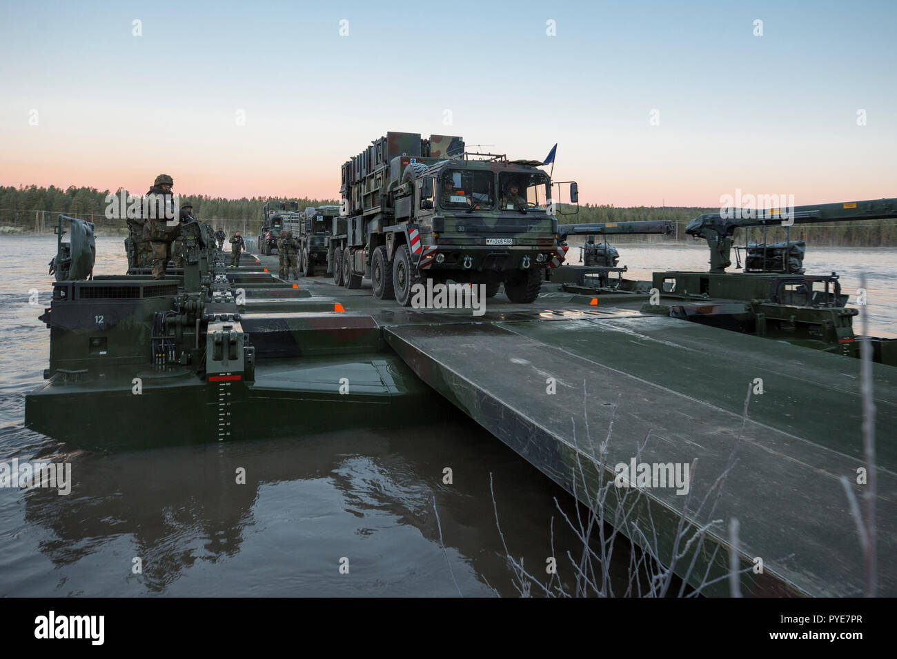 Die deutschen Soldaten aus der 2. Firma multinationalen Engineer Battalion der Sehr hohe Bereitschaft, Joint Task Force (VJTF) durch den Fluss zu überqueren, Training auf dem Fluß Rena mit amphibischen Fähre Fahrzeuge M3. Crossing Over-Rakete (SAM) System Patriot aus der deutschen Luftwaffe. NATO-Übung Trident Punkt in Norwegen, Rena am 24. Oktober 2018. Foto: SGM Marco Dorow, Bundeswehr Stockfoto