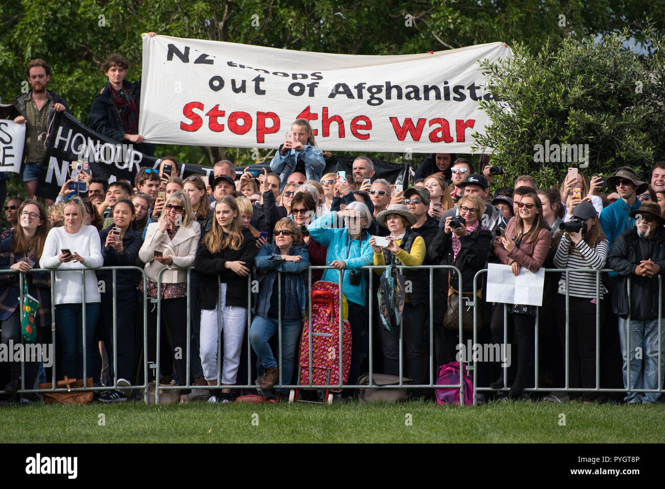 Anti-kriegs-Demonstranten unter den Massen warten, um den Herzog und die Herzogin von Sussex während einer öffentlichen Rundgang Bei einem Besuch der neu vorgestellte UK War Memorial und Pukeahu National War Memorial Park, in Wellington zu sehen, am ersten Tag der Tour ist das königliche Paar von Neuseeland. Stockfoto