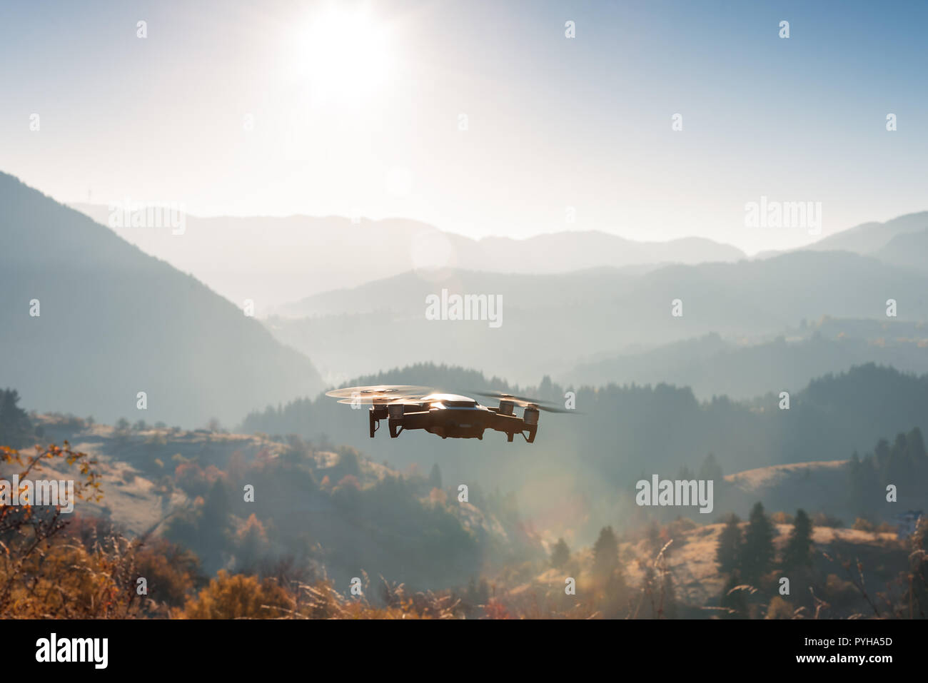 Kleine moderne Drone schweben Sie Bilder von Sunrise in Berg im Herbst. Stockfoto