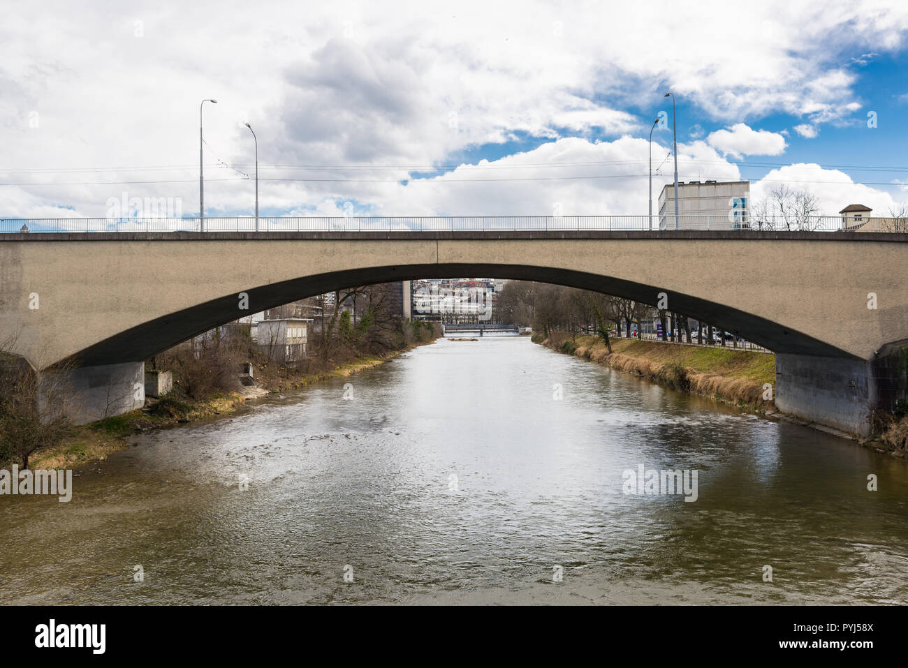 Brücke in konkreten einzelnen Bogen auf eine kleine städtische Fluss Stockfoto