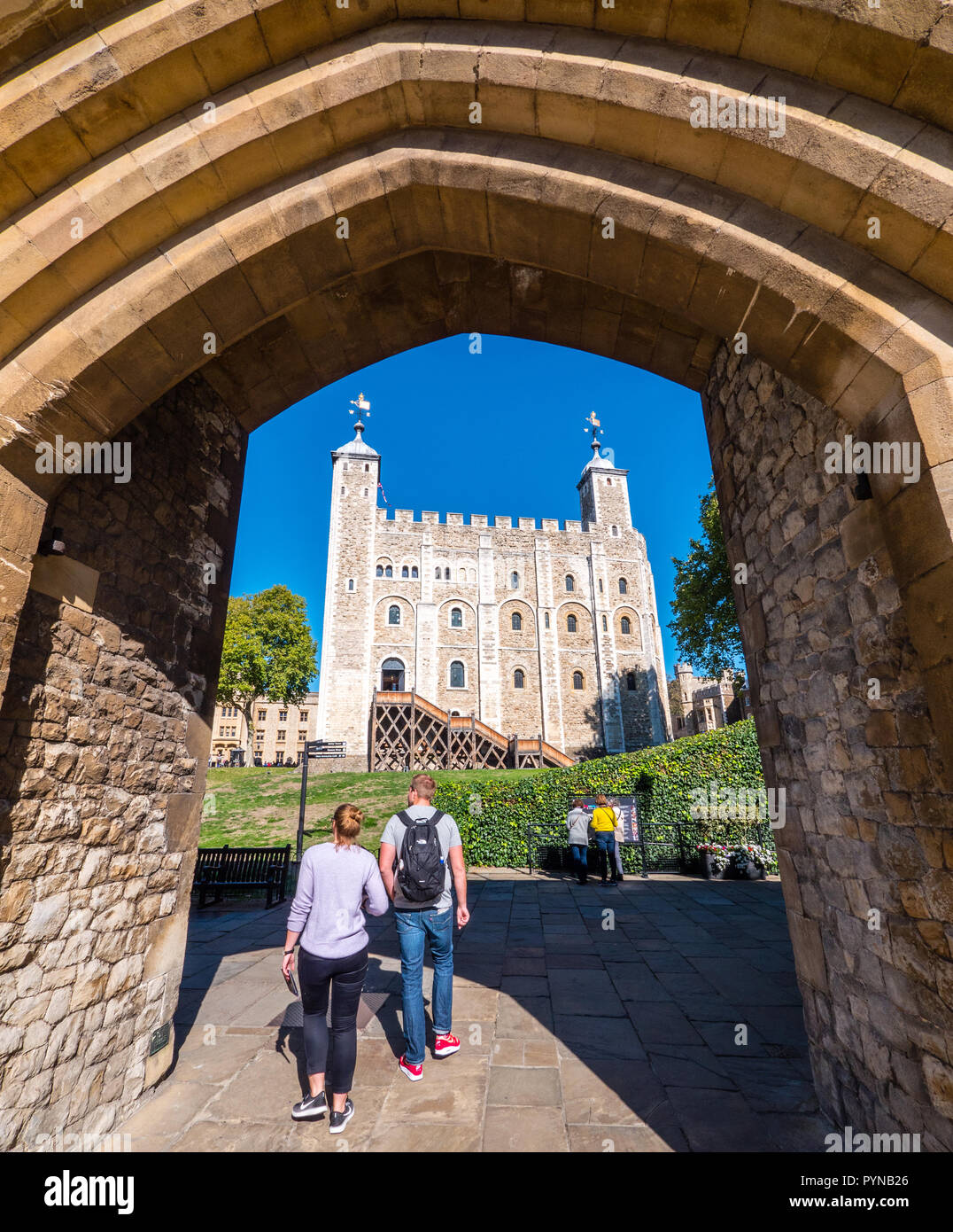 Touristen wandern, Tor zum Innersten Bezirk, mit White Tower, Tower of London, London, England, UK, GB. Stockfoto