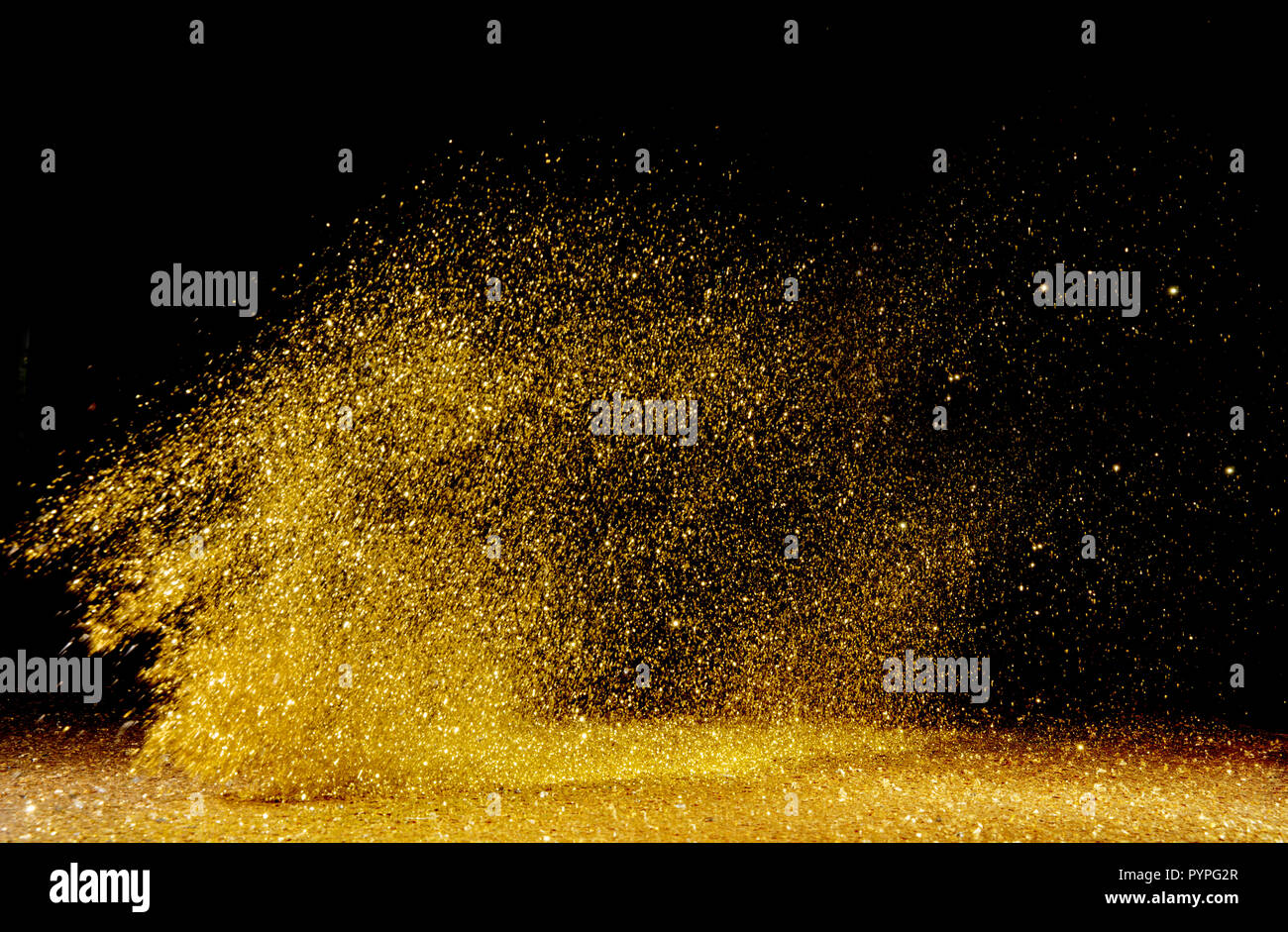 Goldene, glänzende Puder über den dunklen Hintergrund verstreut Stockfoto