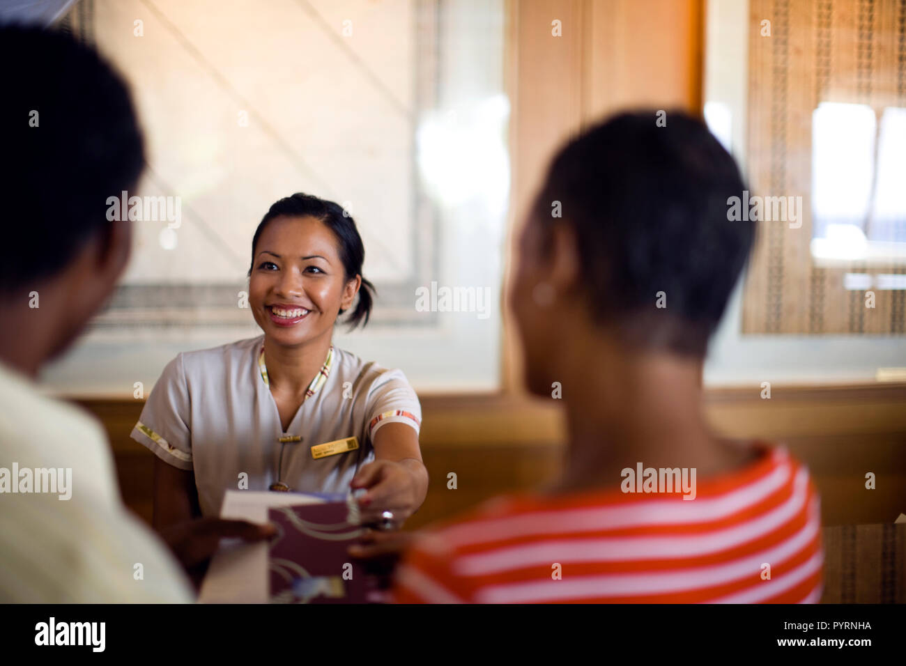 Rezeptionist Kontrolle ein Paar in ihre Hotelzimmer. Stockfoto